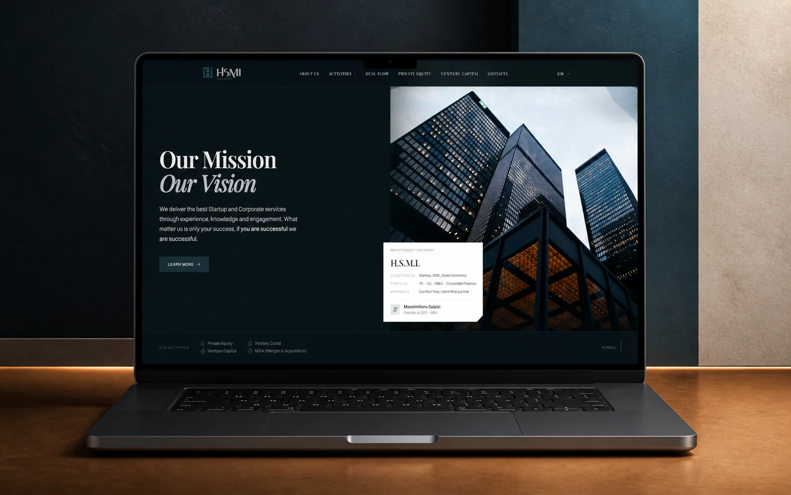 HSMI website hero displayed on a dark-metal laptop in a charcoal, steel-teal, limestone, and amber architectural studio